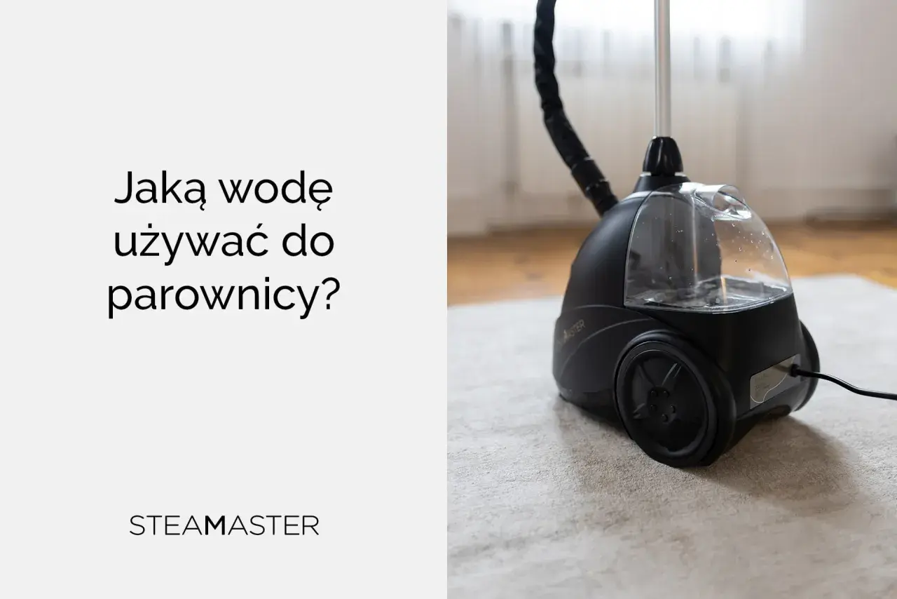 Jaka woda do parownicy? Czarna parownica Steam Master z przezroczystym zbiornikiem na wodę, stojąca na jasnym dywanie.